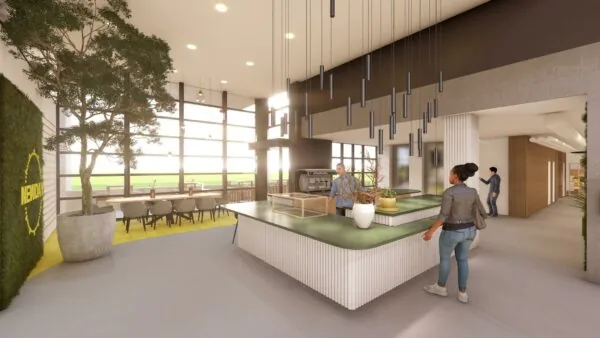 Moderne kantoorlounge aan de Marten Meesweg met een koffiebar, zitgedeelte en veel natuurlijk licht.